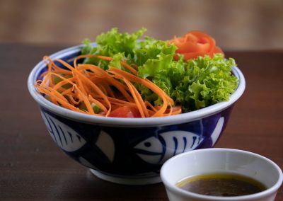 leafy green salad and carrots in a bowl